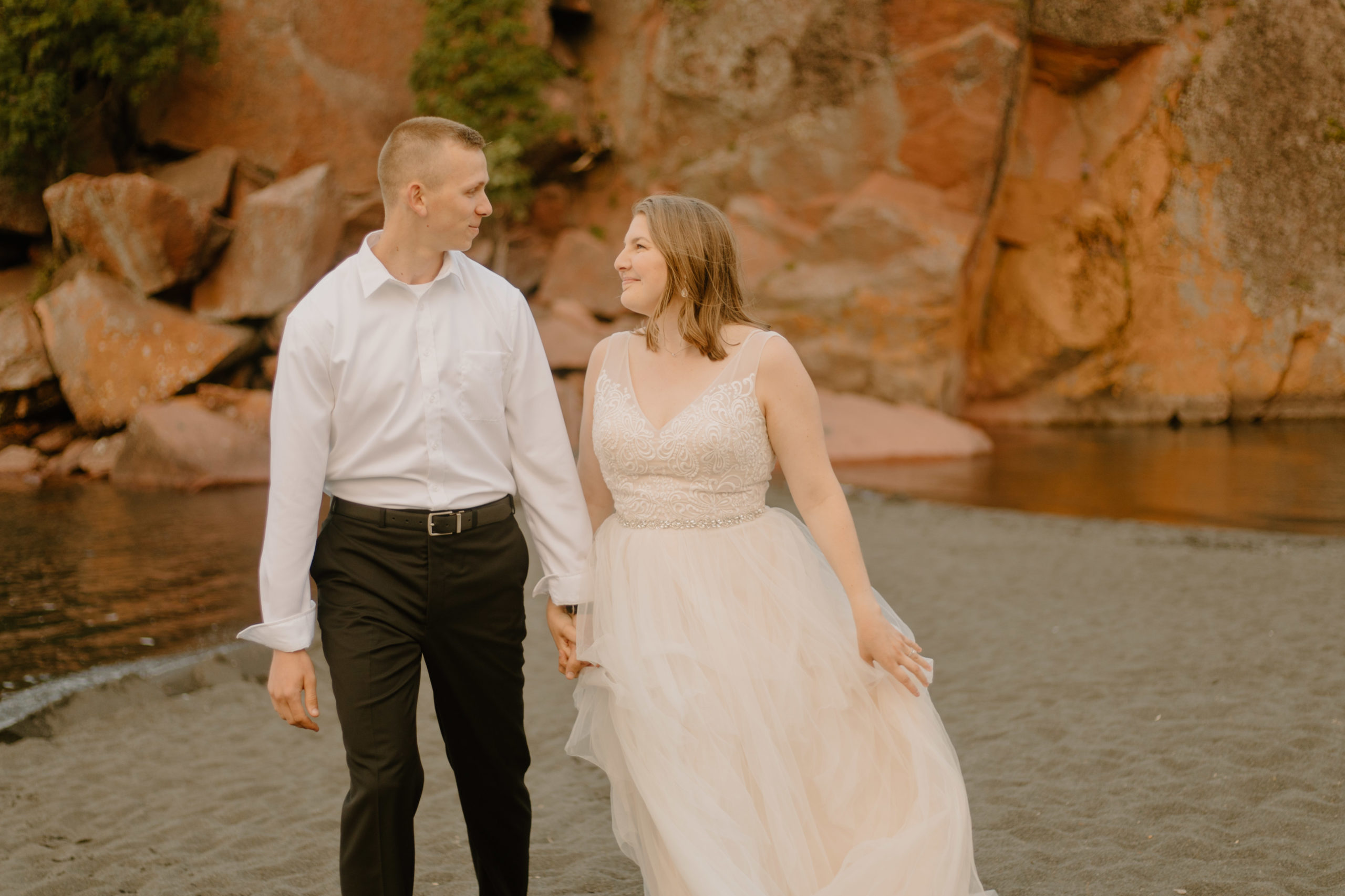 elopement couple walking hand in hand on the beach