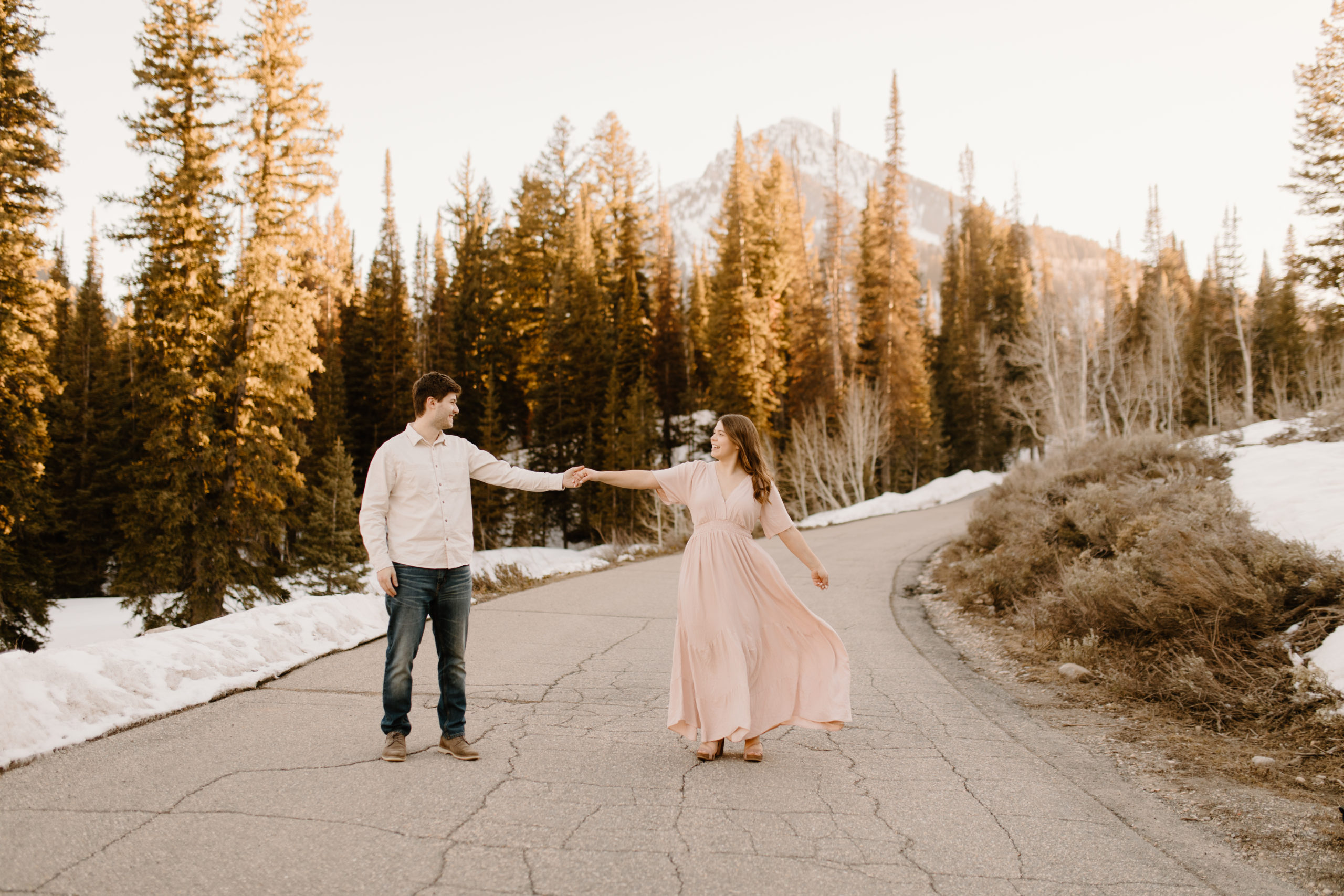 couple dancing for their engagement photos at big cottonwood canyon in utah