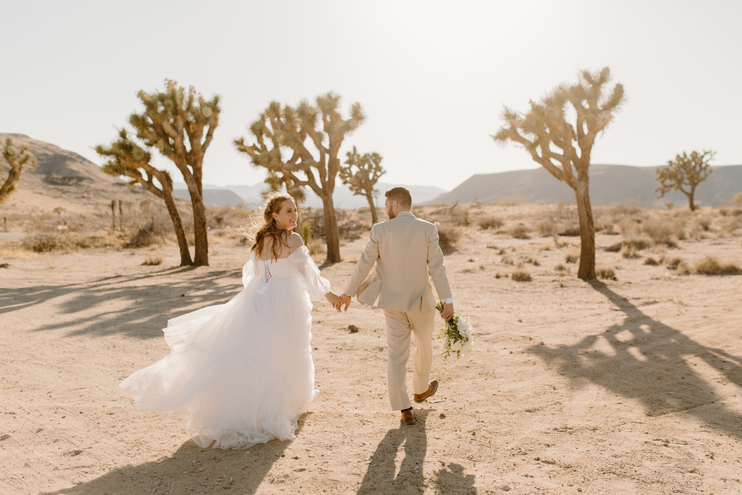 bride and groom walking around after getting married at joshua tree national park