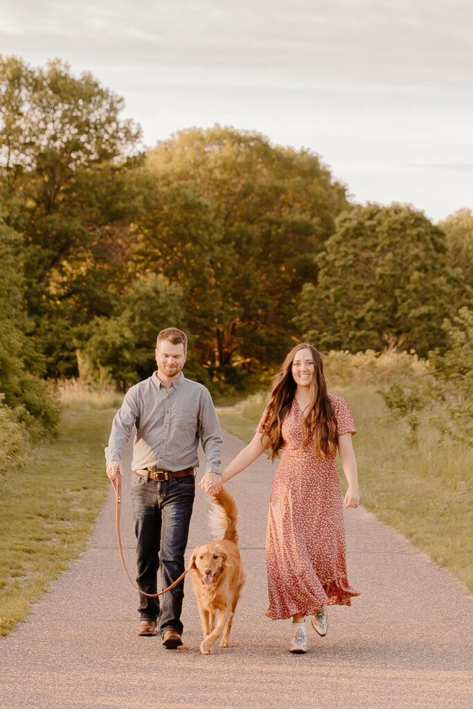 couple walking with their dog at rice creek park 