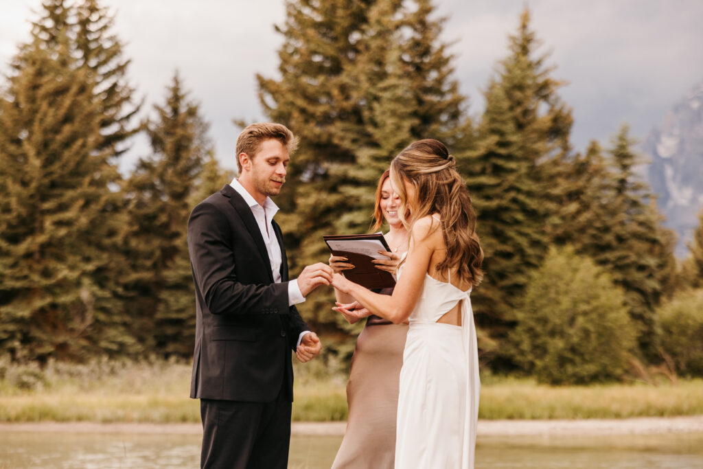 groom and bride exchanging rings at their grand teton elopement